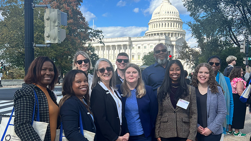 Advocacy team standing in front of capitol